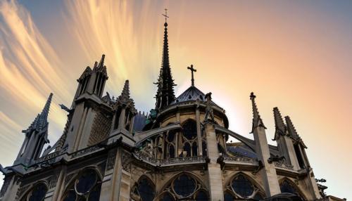 Firefly cathedral of notre dame in paris perspective from below, spires and gargoyles silhouetted ag